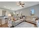 Bright living room with a plush sofa, ceiling fan, and an open floor plan seamlessly connecting to the dining area at 11 Lateen Sail Dr, Placida, FL 33946