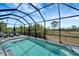Beautiful screened-in pool features lounge chairs and landscaping views at 11 Lateen Sail Dr, Placida, FL 33946