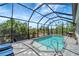Relaxing screened-in pool area with brick pavers, lovely landscaping views, and lounge chairs at 11 Lateen Sail Dr, Placida, FL 33946