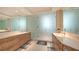 Bright bathroom featuring a dual vanity, white countertops, and a large, frosted glass shower at 111 S Pineapple Ave # 1210, Sarasota, FL 34236