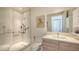 Modern bathroom featuring large glass shower with safety bars, sink with blond wood cabinets, and marble floors at 111 S Pineapple Ave # 1210, Sarasota, FL 34236