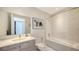 Bathroom features a marble tiled shower over tub, picture and art on the walls, and vanity at 111 S Pineapple Ave # 1210, Sarasota, FL 34236