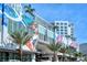 Modern building featuring unique murals, palm trees, and architectural design at 111 S Pineapple Ave # 1210, Sarasota, FL 34236
