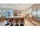 Modern kitchen island with seating, stainless steel appliances, and an adjacent dining area at 111 S Pineapple Ave # 1210, Sarasota, FL 34236