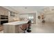 Modern kitchen featuring an island with seating, stainless steel appliances, and sleek cabinetry at 111 S Pineapple Ave # 1210, Sarasota, FL 34236