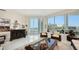 Light-filled living space featuring unique art pieces, comfortable seating, and sliding glass doors leading to the balcony at 111 S Pineapple Ave # 1210, Sarasota, FL 34236