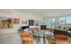 Open-concept room showcases a dining area, piano, floor-to-ceiling windows, and comfortable seating at 111 S Pineapple Ave # 1210, Sarasota, FL 34236