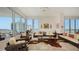 Bright living room featuring large windows, a unique rug, and comfortable seating for relaxation or entertainment at 111 S Pineapple Ave # 1210, Sarasota, FL 34236