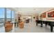 Open living space featuring modern kitchen, dining area, and a piano, creating an inviting and elegant atmosphere at 111 S Pineapple Ave # 1210, Sarasota, FL 34236