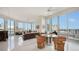 Bright living room with floor to ceiling windows, dining table, and access to balcony with beautiful city views at 111 S Pineapple Ave # 1210, Sarasota, FL 34236