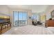 Bright main bedroom with sleek tile floors, balcony access, and city views at 111 S Pineapple Ave # 1210, Sarasota, FL 34236