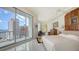 Bright bedroom with balcony access and serene views, featuring sleek tile floors and stylish furnishings at 111 S Pineapple Ave # 1210, Sarasota, FL 34236