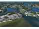 A sweeping aerial photograph of a boat ramp, parking, and surrounding waters, with a view of adjacent waterfront homes at 1112 65Th Nw St, Bradenton, FL 34209