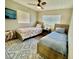 Bright bedroom featuring two twin beds, ceiling fan, and a cozy atmosphere at 1112 65Th Nw St, Bradenton, FL 34209