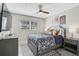 Primary bedroom with a ceiling fan, neutral walls, window, and decorative textiles at 1112 65Th Nw St, Bradenton, FL 34209