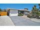 Well-maintained single-story home with a garage, eye-catching blue door, and tidy landscaping at 1112 65Th Nw St, Bradenton, FL 34209