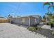 Rear exterior featuring a patio, screened pool, and gravel landscaping at 1112 65Th Nw St, Bradenton, FL 34209
