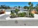 Inviting front exterior with tropical landscaping, lawn, driveway and single car garage at 1112 65Th Nw St, Bradenton, FL 34209