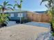 Gravel front yard featuring vibrant landscaping and palm trees at 1112 65Th Nw St, Bradenton, FL 34209