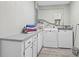 Laundry room with side by side washer and dryer, a folding counter, and painted neutral walls at 1112 65Th Nw St, Bradenton, FL 34209