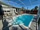 Relaxing enclosed pool with clear water and poolside seating offers a refreshing escape in a private outdoor setting at 1112 65Th Nw St, Bradenton, FL 34209