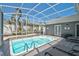 Inviting screened in pool with palm trees, perfect for cooling off on a hot day at 1112 65Th Nw St, Bradenton, FL 34209