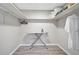 Walk-in closet with wooden floors, white walls, metal shelving, and an ironing board at 1112 65Th Nw St, Bradenton, FL 34209