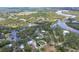 Aerial view showcases home's location along a scenic waterway and surrounded by mature trees and natural beauty at 1130 Mill Creek Rd, Bradenton, FL 34212