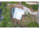 Bird's-eye view features an oversized lot with pool, patio, and mature trees surrounding the home at 1130 Mill Creek Rd, Bradenton, FL 34212