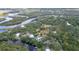 Aerial view of homes nestled among lush greenery along the water, offering a tranquil retreat at 1130 Mill Creek Rd, Bradenton, FL 34212