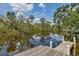 Backyard view from the end of the private dock overlooking peaceful waters surrounded by lush, mature Florida landscaping at 1130 Mill Creek Rd, Bradenton, FL 34212