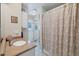 Well-lit bathroom featuring a single sink vanity, white cabinets, and tiled floors at 1130 Mill Creek Rd, Bradenton, FL 34212