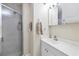 Bright bathroom features a glass door shower, single sink vanity and vanity mirror at 1130 Mill Creek Rd, Bradenton, FL 34212