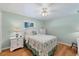Cozy bedroom features a ceiling fan, wood floors, and a comfortable bed at 1130 Mill Creek Rd, Bradenton, FL 34212