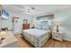 Bedroom boasts light blue walls, wood floors, a ceiling fan, and a window at 1130 Mill Creek Rd, Bradenton, FL 34212