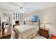 Cozy bedroom with a ceiling fan, a window view, and built-in display shelving at 1130 Mill Creek Rd, Bradenton, FL 34212