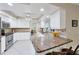 Bright kitchen with granite countertops, white cabinetry, and stainless steel appliances at 1130 Mill Creek Rd, Bradenton, FL 34212