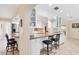 Kitchen features a breakfast bar, granite counters, white cabinets, and stainless steel appliances at 1130 Mill Creek Rd, Bradenton, FL 34212