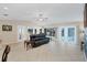 Living room featuring tile flooring, vaulted ceiling, and view of the lanai and pool at 1130 Mill Creek Rd, Bradenton, FL 34212