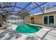 Screened in swimming pool with a seating area, a tanning deck, and enclosed pool at 1130 Mill Creek Rd, Bradenton, FL 34212