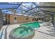 Screened in pool and hot tub features a seating area, spa, and tanning deck at 1130 Mill Creek Rd, Bradenton, FL 34212