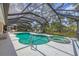 Relax and unwind in this private screened pool and spa area with outdoor seating at 1130 Mill Creek Rd, Bradenton, FL 34212