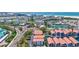 Aerial shot of beachfront condos with terracotta roofs, offering stunning views and proximity to the beach at 1155 Lake House Cir # C119, Sarasota, FL 34242