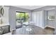 Cozy dining area with balcony access and views of lush greenery at 1155 Lake House Cir # C119, Sarasota, FL 34242