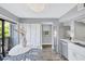 Efficient kitchen features stainless appliances, white cabinetry, and dining area adjacent to outdoor access at 1155 Lake House Cir # C119, Sarasota, FL 34242