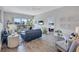 Stylish living room with wood floors, balcony views, a comfortable sofa, and views of the bedroom at 1155 Lake House Cir # C119, Sarasota, FL 34242