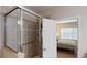 Bathroom showing the shower behind glass doors with a view into the bedroom at 116 Navigation Cir # 106, Osprey, FL 34229