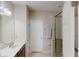Bathroom featuring a double vanity sink and a glass door shower at 116 Navigation Cir # 106, Osprey, FL 34229