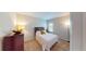 Bedroom featuring a wood-framed bed, side table, and neutral decor at 116 Navigation Cir # 106, Osprey, FL 34229