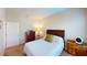 Comfortable bedroom with a wooden bed frame, matching dressers, and soft carpet flooring at 116 Navigation Cir # 106, Osprey, FL 34229